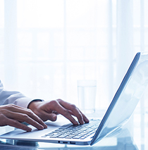 man typing into a computer